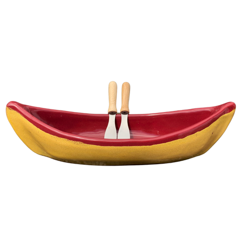 Red and gold canoe with two spatulas as paddles.